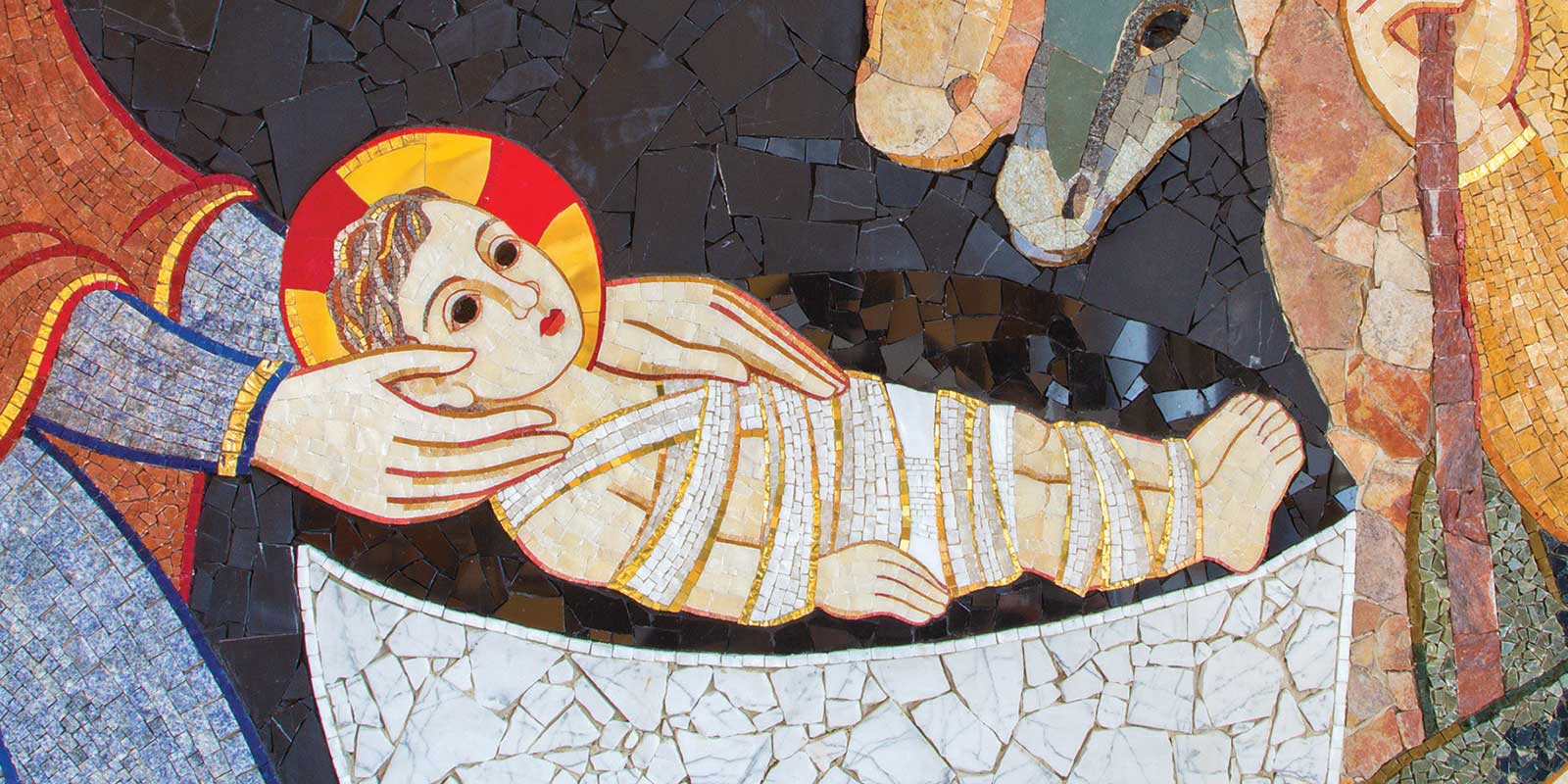 A mosaic with Mary and Joseph with baby Jesus.