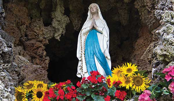 Statue of Our Lady of Lourdes in a grotto